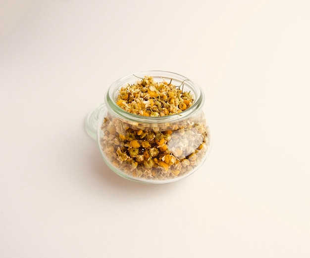 dried yellow chamomile flowers isolated in a glass jar