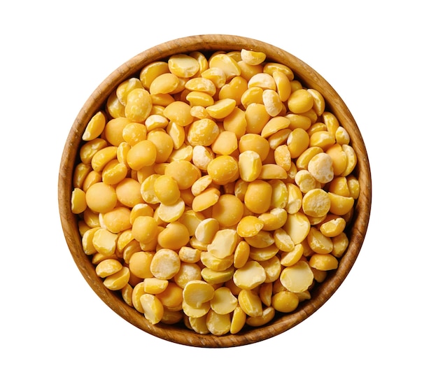 Dried yellow splin peas in wooden bowl isolated on white background. Top view