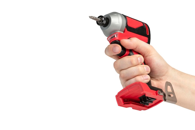 Photo drill in hand on a white isolated background cordless drill or screwdriver in a male hand removable lithium battery casts a shadow the concept of selling and using cordless tools