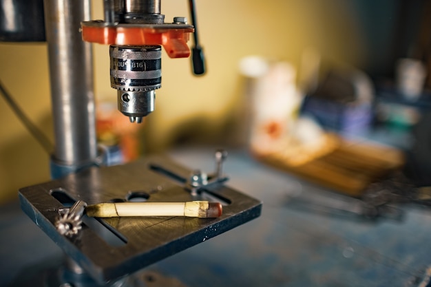 Drilling machine at the workplace in workshop