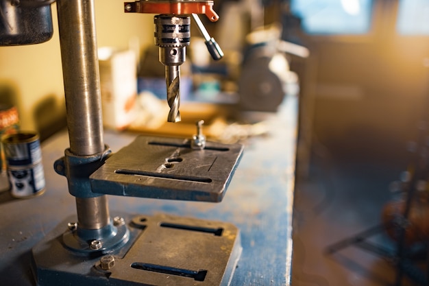 Drilling machine at the workplace in workshop