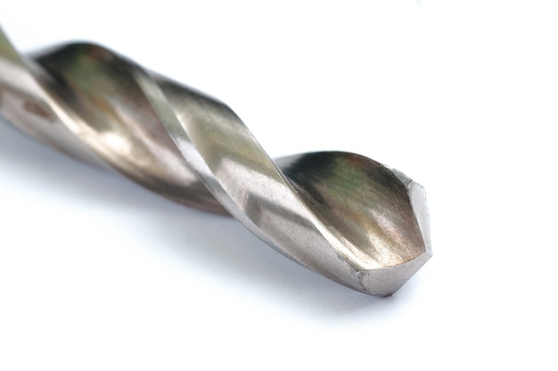 Photo drilling tool. steel drill bit on white background. close-up view