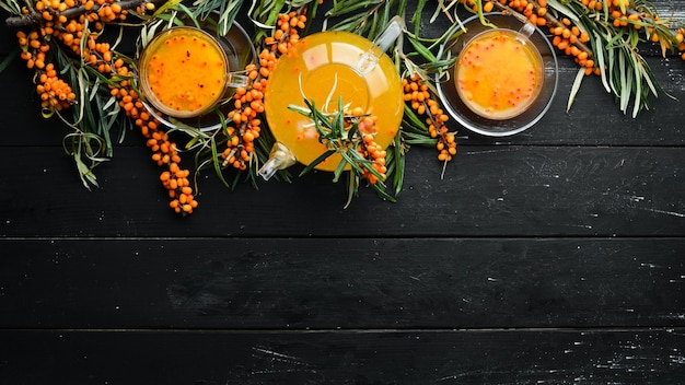 Drink from sea buckthorn berries Winter hot drink Fresh sea buckthorn on a twig Top view Free space for your text