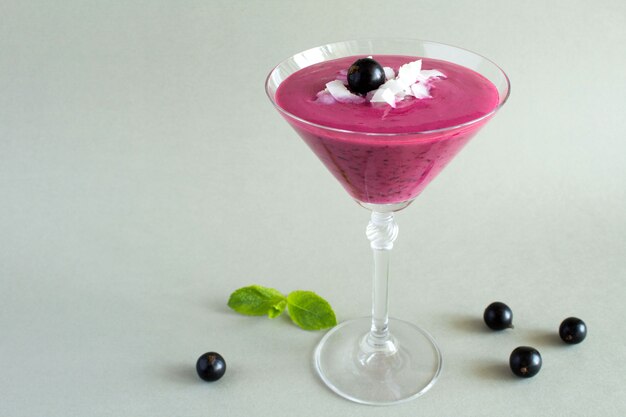 Drink made of black currant in tall glass