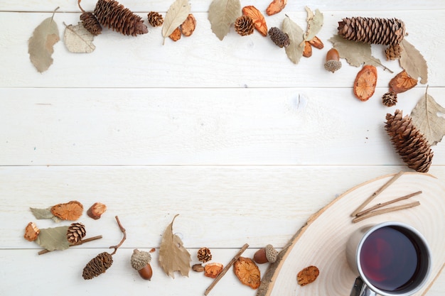 Drink in a retro mug on a wooden background in the autumn style . top view