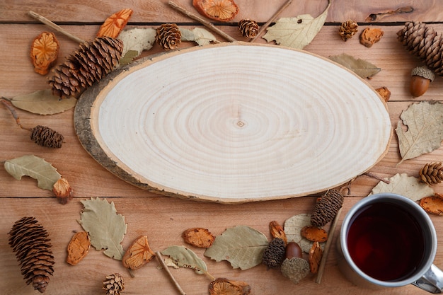 Drink in a retro mug on a wooden background in the autumn style . top view