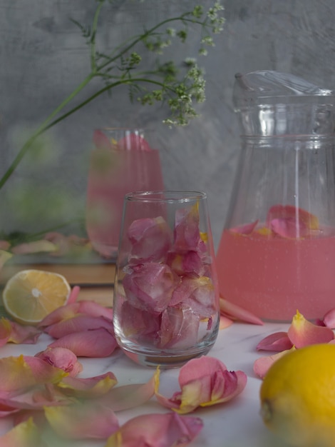 a drink with ice cubes with flowers in a glass