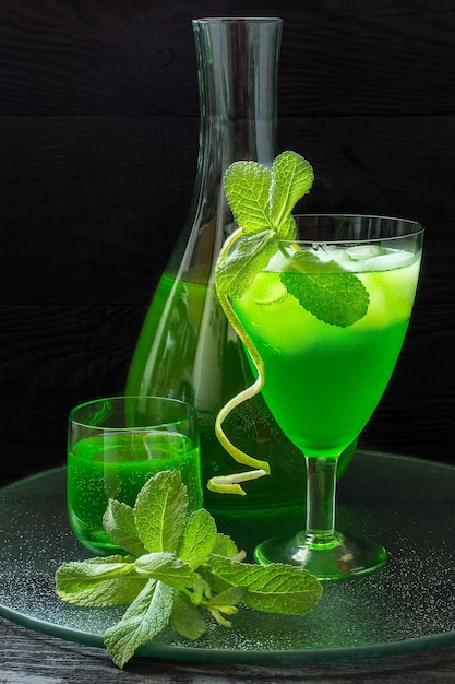 Drink with tarragon and mint cocktail with ice