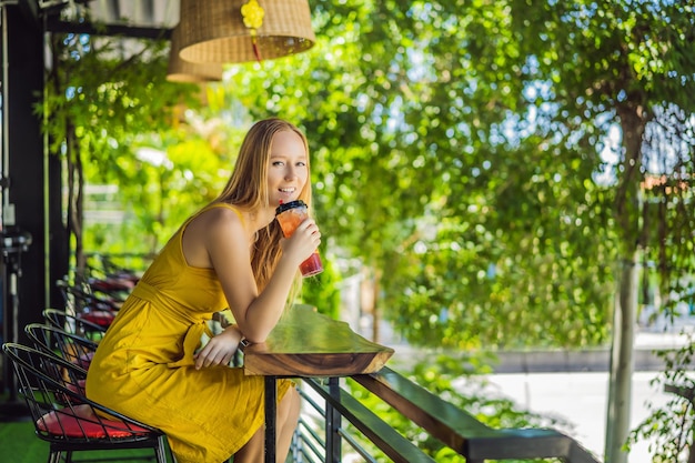 Drinking aperol spritz at summer terrace elegant woman drinking iced summer cocktail