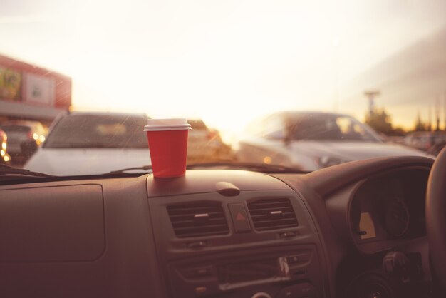 Drinking coffee in paper cup during the journey in the car