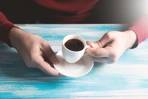 Drinking coffee and reading a book on the table