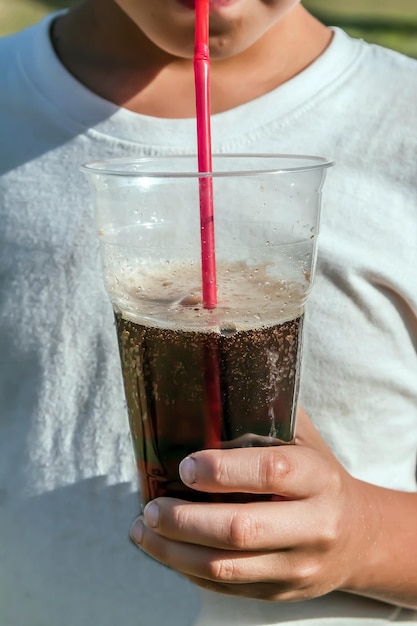 Drinking a drink from a plastic cup