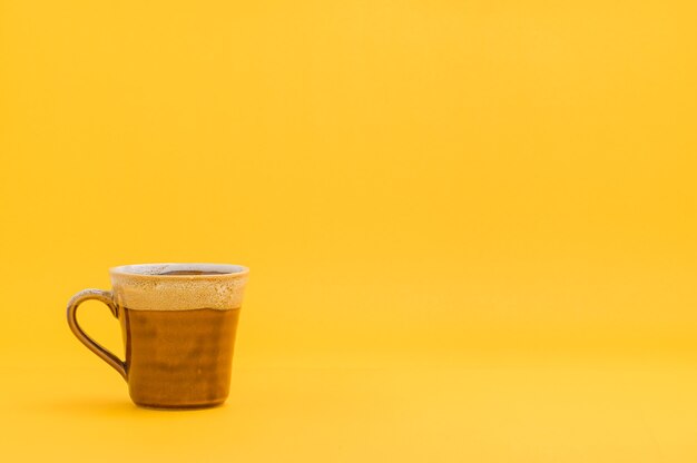 Photo drinking glass, coffee mug with yellow background