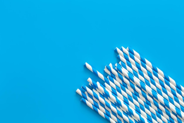 Drinking straws for party on blue background flat lay copy space