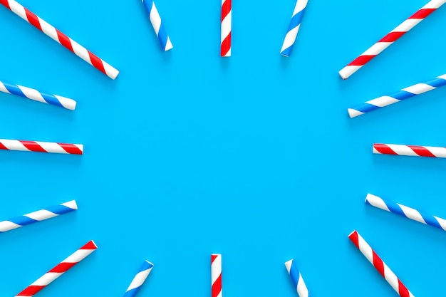 Drinking straws for party on blue background with copy space