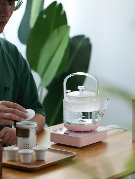 Drinking tea has many benefits for the body and mind A man pours a cup of tea into a teapot