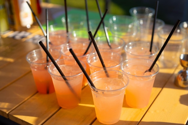 drinks with ice in transparent plastic glasses