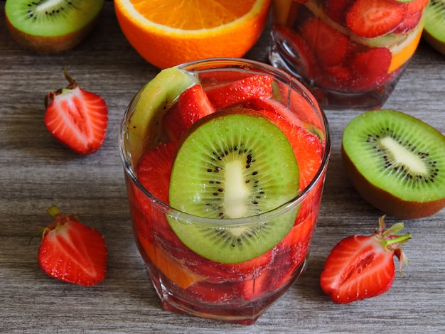 Drinks with strawberries, kiwi, and orange.