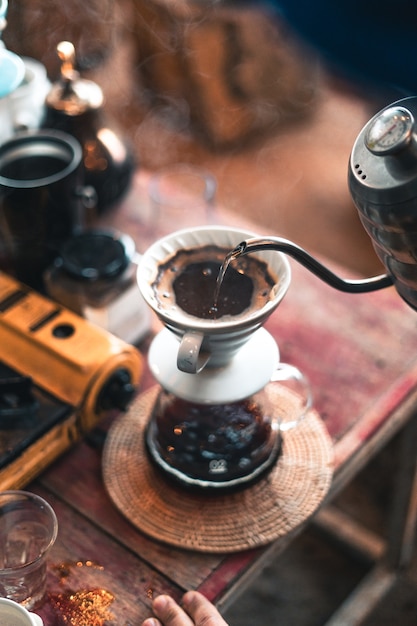 Drip coffee, barista pouring water on coffee ground with filter,brewing coffee