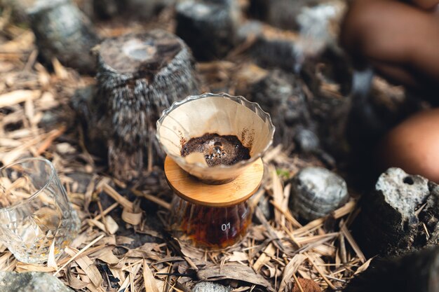 Drip coffee in the forest,pour hot water in coffee