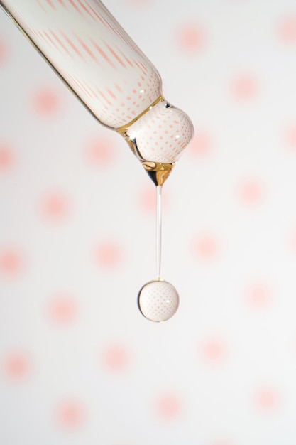 Photo a dripping pipette with a drop of cosmetics gel