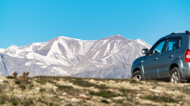 Drive a car to the snowy mountain peaks