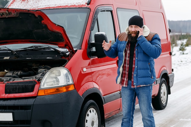 Driver call technical assistance on the road in winter. 