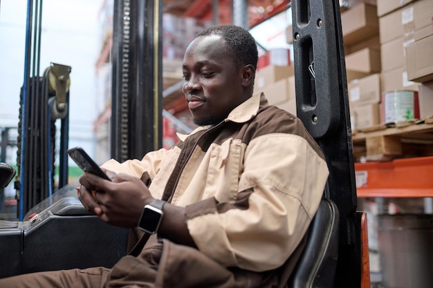 Driver of forklift using mobile phone