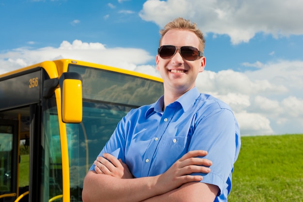 Driver in front of his bus