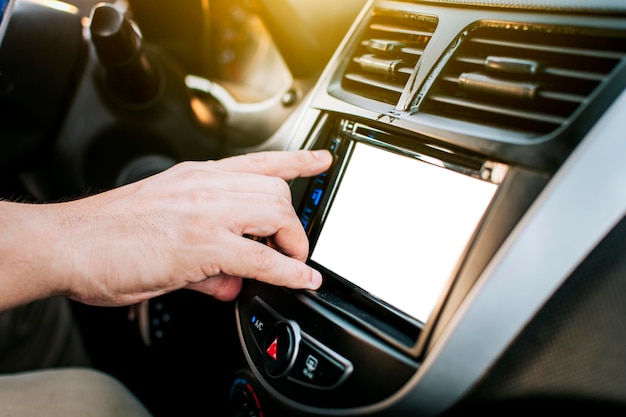 Driver hands changing the radio station close up of hands
changing the car radio station concept of driver tuning the radio
driver man changing radio station