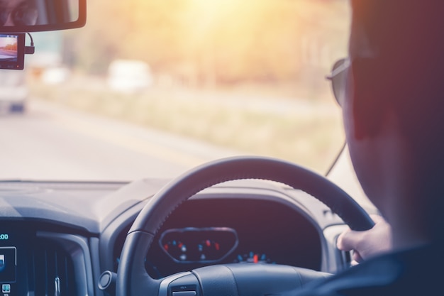 Driver hands holding steering wheel