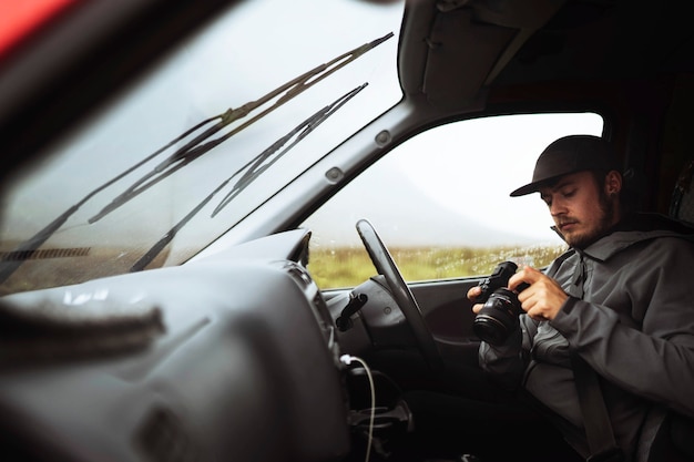 Driver holding a professional camera