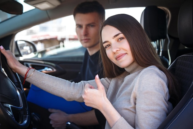 The driver is an auto school instructor and a female student on an examination car