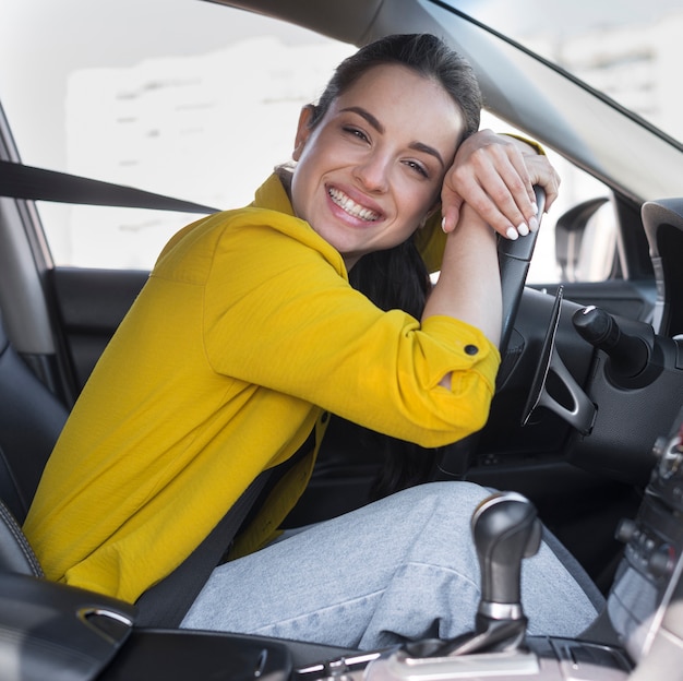 Photo driver smiles and leaning on the steering wheel