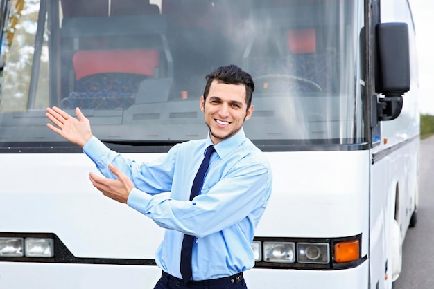 Driver standing in front of bus