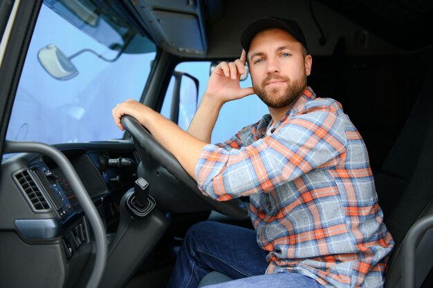 Photo driver behind the wheel in truck cabin