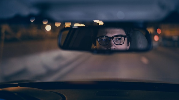 Premium Photo | Driver39s face is reflected in a rear view mirror night ...