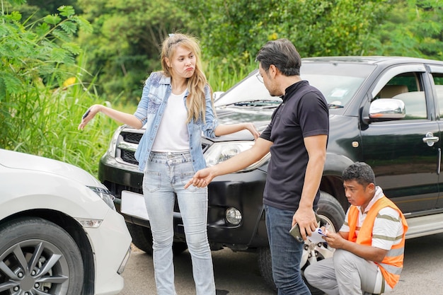 Drivers stood arguing after the car crashed with insurance company officer checking car damages