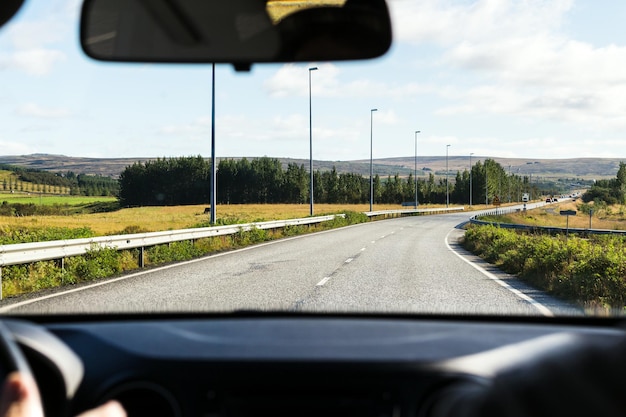 Driving at country road in Iceland in sunny day