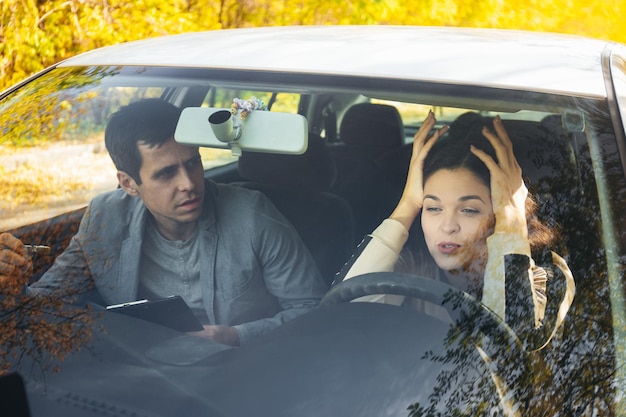 A driving instructor yells at a student girl at the wheel Got into an accident