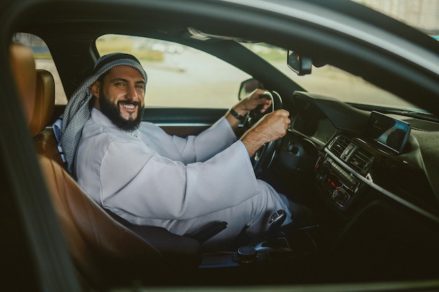 Driving Saudi man driving a car and feeling good