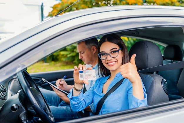 Photo driving school. beautiful young woman successfully passed driving school test. she looking