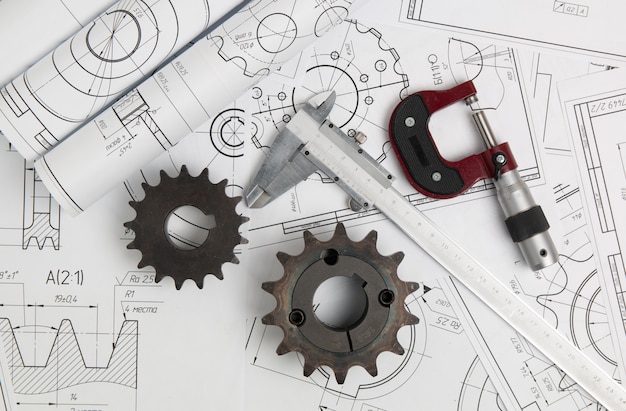 Driving sprockets, caliper, micrometer and engineering drawings of industrial parts and mechanisms