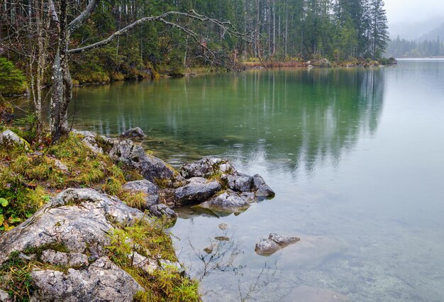 Drizzly rain on alpine autumn lake Hintersee Alps Bavaria Germany