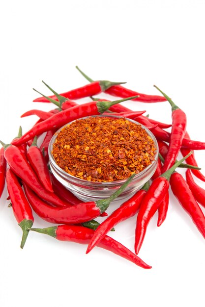 Droge gemalen peper en rode chili peper op wit