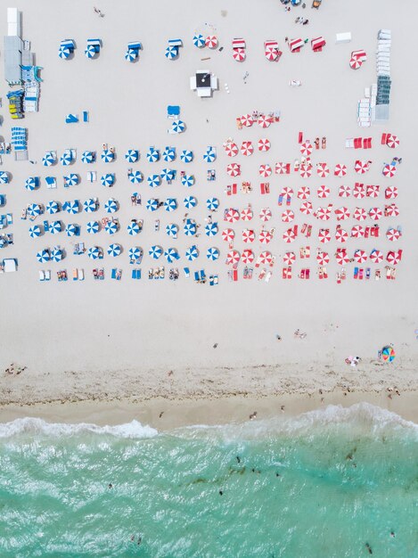 Drone Aerial View At Miami South Beach Florida Beach With Colorful Chairs And Umbrellas