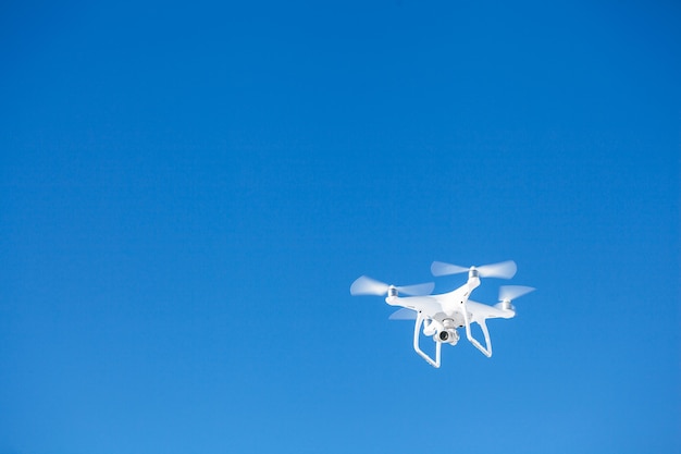 Drone copter flying with digital camera over the mountains