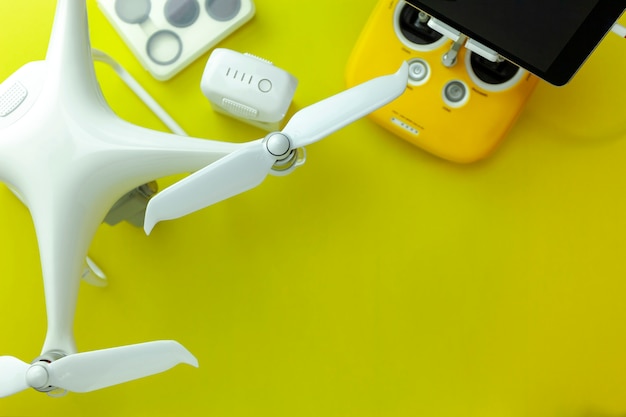 Drone equipment with Remote control on yellow paper background, copy space for your text Top view image