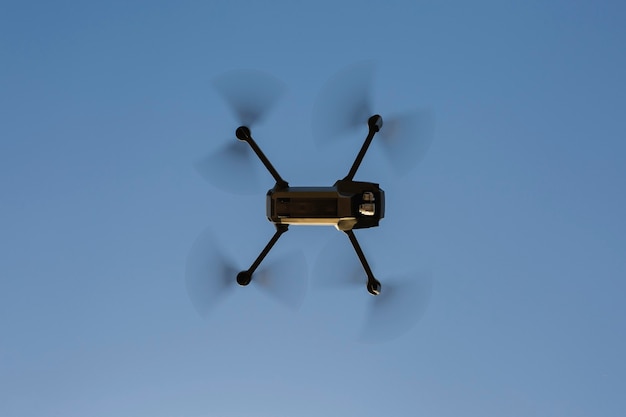Drone flying against a blue sky