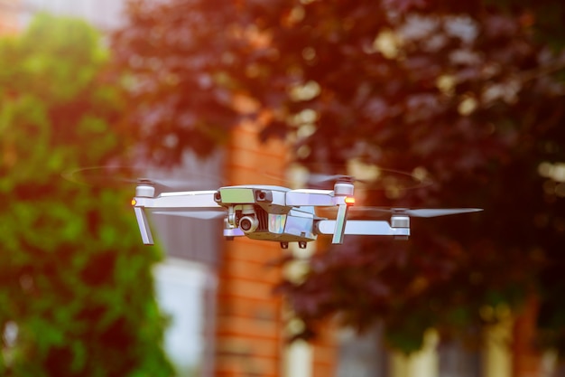 Drone flying above city at sunset